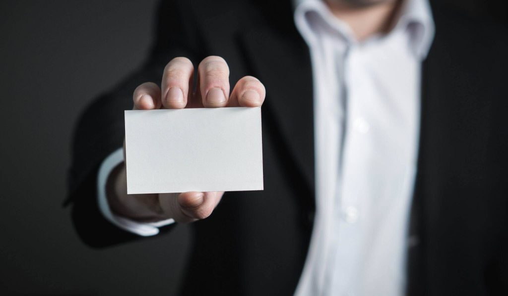 man showing his Japanese business card